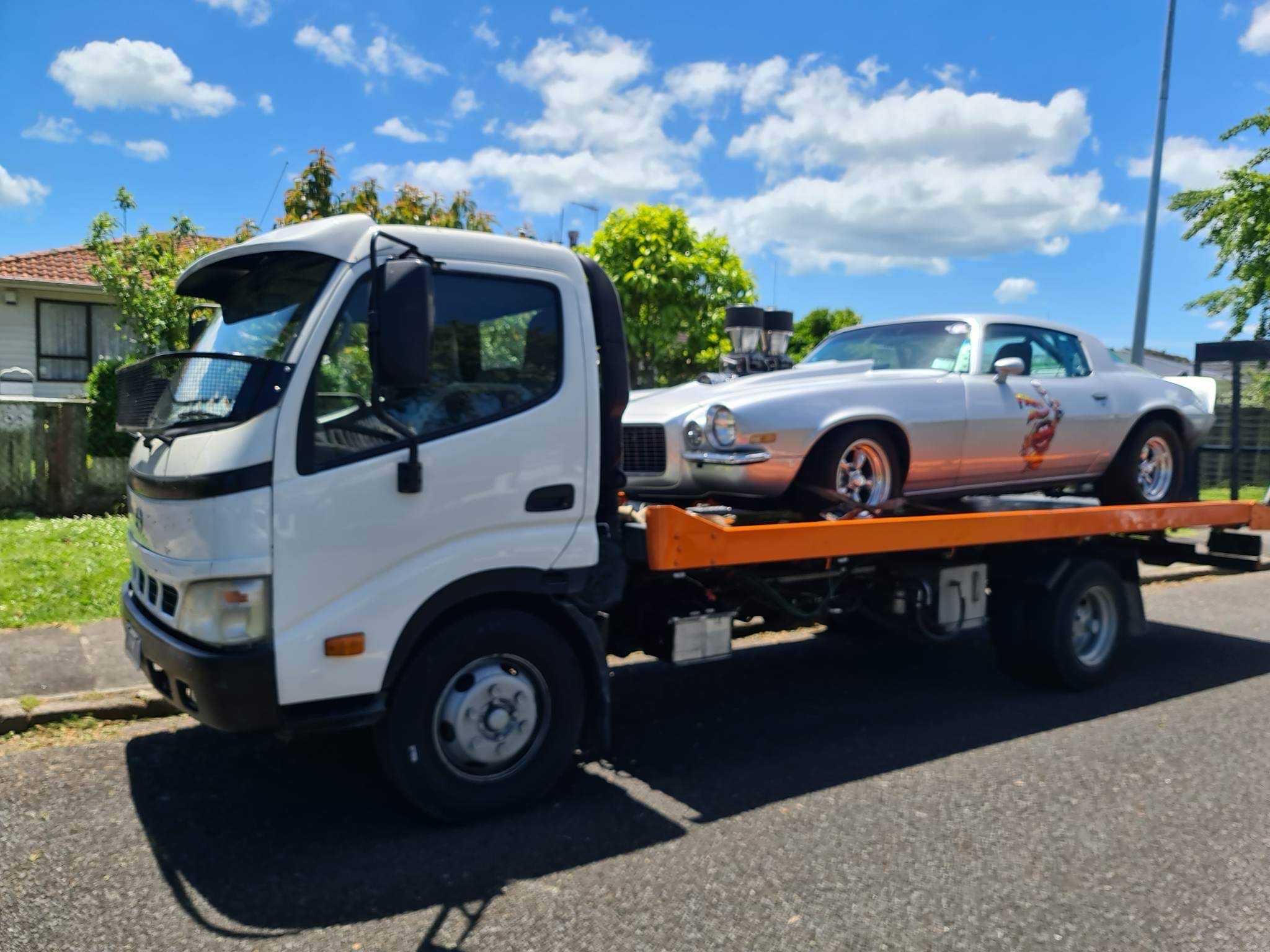 Fast Towing flatbed truck transporting a car in Auckland